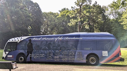 The Greensboro bus with the Black patriots wrap on display at Guilford Courthouse National Military Park. Photo by Bernetiae Reed.